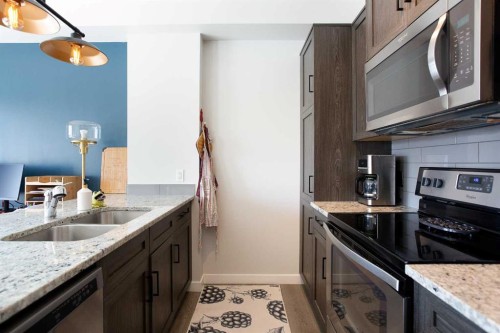 412-250 Fireside View, Cochrane, AB - Indoor Photo Showing Kitchen With Stainless Steel Kitchen With Double Sink With Upgraded Kitchen