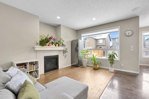 177 Cougar Ridge Close Sw, Calgary, AB - Indoor Photo Showing Living Room With Fireplace