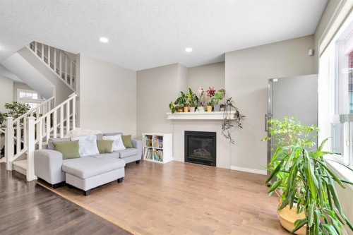 177 Cougar Ridge Close Sw, Calgary, AB - Indoor Photo Showing Living Room With Fireplace