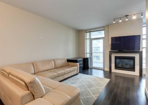 414-222 Riverfront Avenue Sw, Calgary, AB - Indoor Photo Showing Living Room With Fireplace