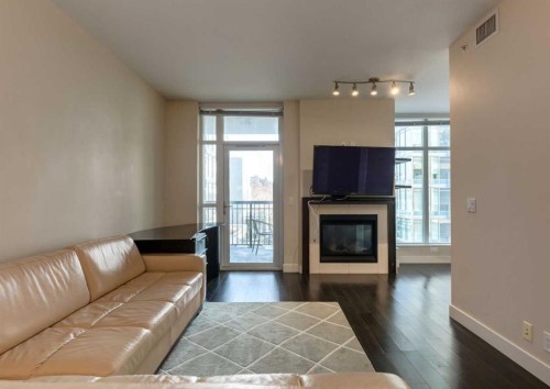 414-222 Riverfront Avenue Sw, Calgary, AB - Indoor Photo Showing Living Room With Fireplace