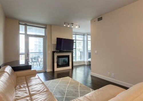 414-222 Riverfront Avenue Sw, Calgary, AB - Indoor Photo Showing Living Room With Fireplace