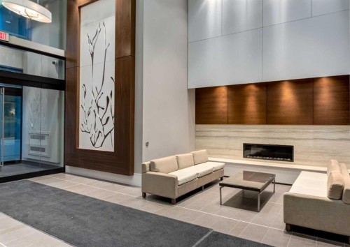 414-222 Riverfront Avenue Sw, Calgary, AB - Indoor Photo Showing Other Room With Fireplace