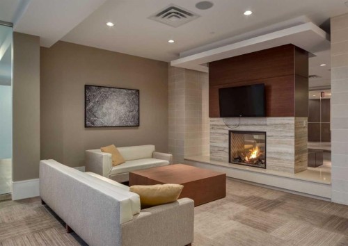 414-222 Riverfront Avenue Sw, Calgary, AB - Indoor Photo Showing Living Room With Fireplace