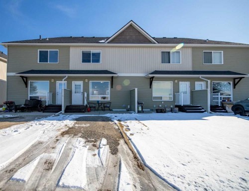 203 Clover Way, Carstairs, AB - Outdoor With Deck Patio Veranda With Facade