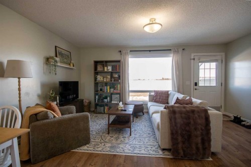 203 Clover Way, Carstairs, AB - Indoor Photo Showing Living Room