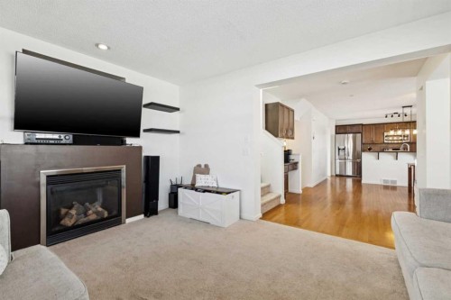 344 Silverado Drive Sw, Calgary, AB - Indoor Photo Showing Living Room With Fireplace