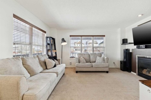 344 Silverado Drive Sw, Calgary, AB - Indoor Photo Showing Living Room With Fireplace