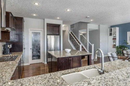 128 Sunset Park, Cochrane, AB - Indoor Photo Showing Kitchen With Double Sink With Upgraded Kitchen