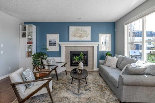 128 Sunset Park, Cochrane, AB - Indoor Photo Showing Living Room With Fireplace