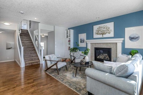 128 Sunset Park, Cochrane, AB - Indoor Photo Showing Living Room With Fireplace