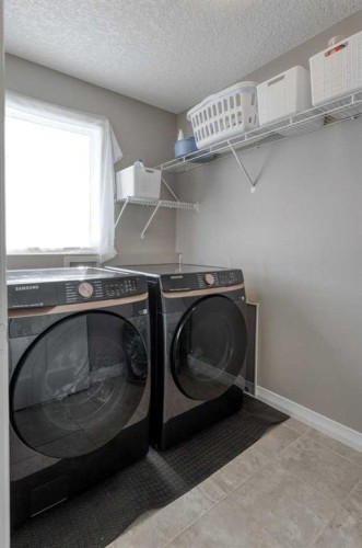 128 Sunset Park, Cochrane, AB - Indoor Photo Showing Laundry Room