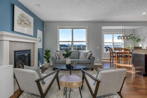 128 Sunset Park, Cochrane, AB - Indoor Photo Showing Living Room With Fireplace