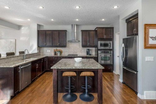 128 Sunset Park, Cochrane, AB - Indoor Photo Showing Kitchen With Upgraded Kitchen