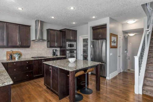 128 Sunset Park, Cochrane, AB - Indoor Photo Showing Kitchen With Upgraded Kitchen