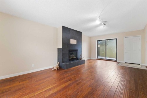10603 Maplecreek Drive Se, Calgary, AB - Indoor Photo Showing Living Room With Fireplace