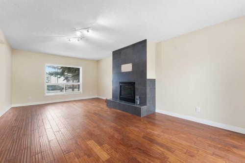 10603 Maplecreek Drive Se, Calgary, AB - Indoor Photo Showing Living Room With Fireplace