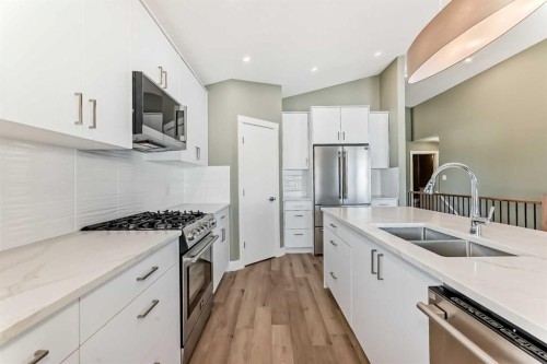 2017 30 Avenue, Nanton, AB - Indoor Photo Showing Kitchen With Stainless Steel Kitchen With Double Sink With Upgraded Kitchen