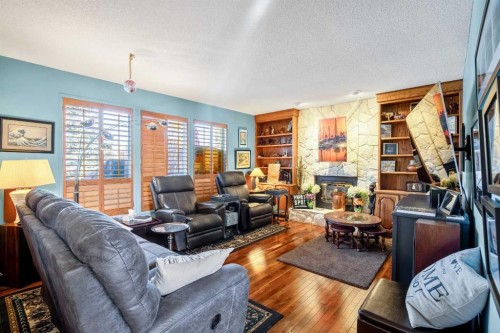 135 Canter Place Sw, Calgary, AB - Indoor Photo Showing Living Room With Fireplace