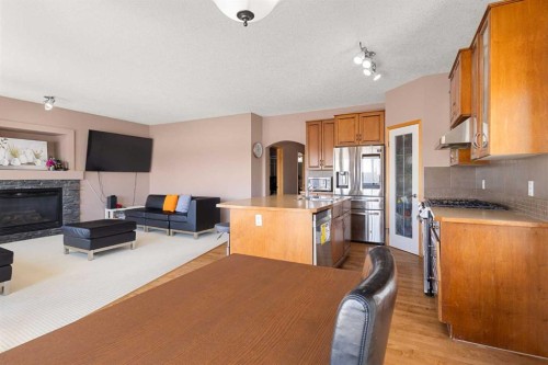 146 Panamount Villas Nw, Calgary, AB - Indoor Photo Showing Kitchen With Fireplace