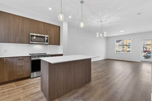 103-40 Creekside Way Sw, Calgary, AB - Indoor Photo Showing Kitchen With Upgraded Kitchen