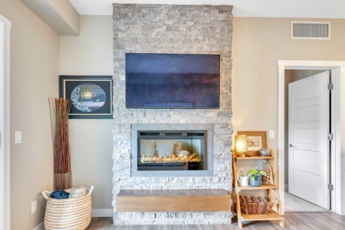 415-55 Wolf Hollow Crescent Se, Calgary, AB - Indoor Photo Showing Living Room With Fireplace