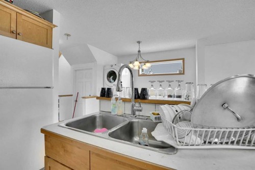 162 Taradale Drive Ne, Calgary, AB - Indoor Photo Showing Kitchen With Double Sink