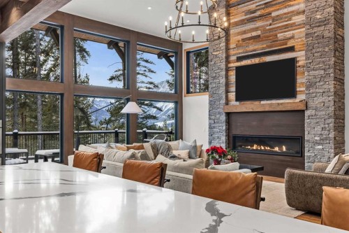 117 Silvertip Ridge, Canmore, AB - Indoor Photo Showing Other Room With Fireplace