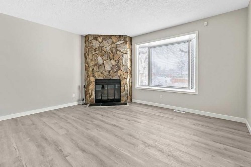 129 Berwick Drive Nw, Calgary, AB - Indoor Photo Showing Living Room With Fireplace