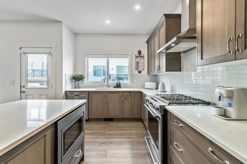 882 Bluerock Way Sw, Calgary, AB - Indoor Photo Showing Kitchen With Upgraded Kitchen