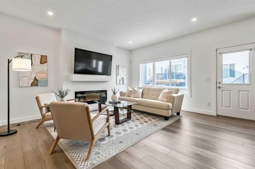 882 Bluerock Way Sw, Calgary, AB - Indoor Photo Showing Living Room With Fireplace
