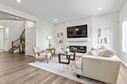 882 Bluerock Way Sw, Calgary, AB - Indoor Photo Showing Living Room With Fireplace