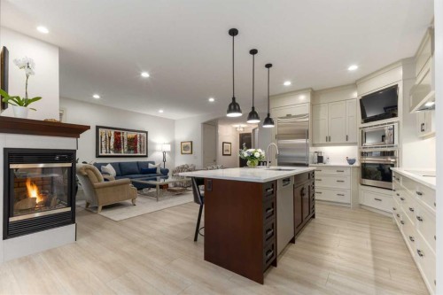 551 Evergreen Circle Sw, Calgary, AB - Indoor Photo Showing Kitchen With Fireplace With Upgraded Kitchen