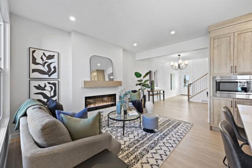 31 Fireside Common West, Cochrane, AB - Indoor Photo Showing Living Room With Fireplace