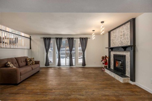 131 Stratton Crescent Sw, Calgary, AB - Indoor Photo Showing Living Room With Fireplace