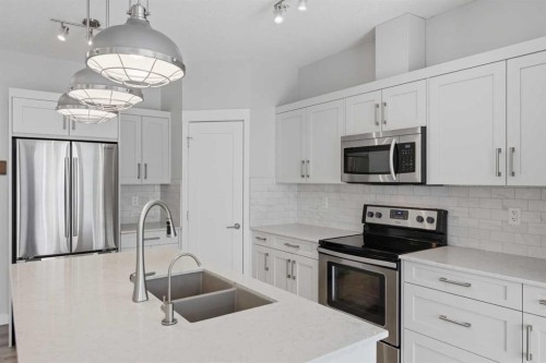 213-20 Walgrove Walk Se, Calgary, AB - Indoor Photo Showing Kitchen With Stainless Steel Kitchen With Double Sink With Upgraded Kitchen