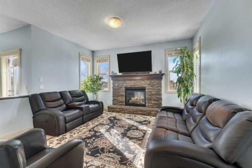 156 Bishop Crescent Nw, Langdon, AB - Indoor Photo Showing Living Room With Fireplace