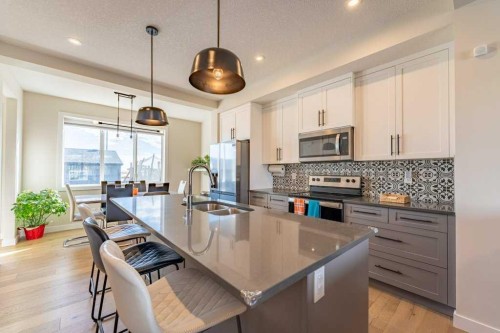 153 Waterford Boulevard, Chestermere, AB - Indoor Photo Showing Kitchen With Double Sink With Upgraded Kitchen