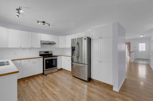 2-200 Sandstone Drive Nw, Calgary, AB - Indoor Photo Showing Kitchen With Double Sink