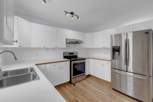 2-200 Sandstone Drive Nw, Calgary, AB - Indoor Photo Showing Kitchen With Double Sink