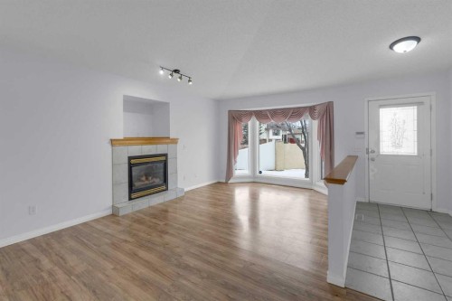 2-200 Sandstone Drive Nw, Calgary, AB - Indoor Photo Showing Living Room With Fireplace