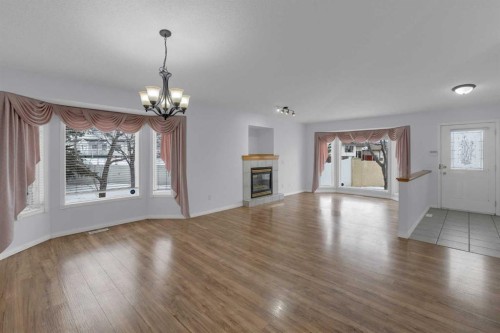 2-200 Sandstone Drive Nw, Calgary, AB - Indoor Photo Showing Living Room With Fireplace