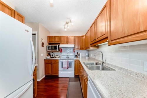 151 Macewan Ridge Villas Nw, Calgary, AB - Indoor Photo Showing Kitchen With Double Sink