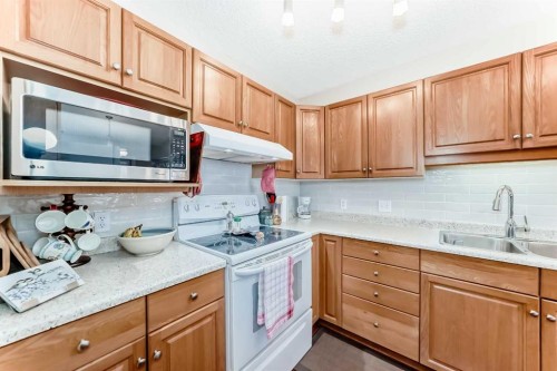 151 Macewan Ridge Villas Nw, Calgary, AB - Indoor Photo Showing Kitchen With Double Sink