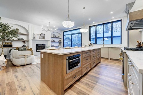 3207 Alfege Street Sw, Calgary, AB - Indoor Photo Showing Kitchen With Fireplace