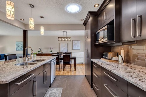 335 Huntbourne Hill Ne, Calgary, AB - Indoor Photo Showing Kitchen With Double Sink