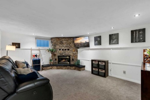 9939 Maplecreek Drive Se, Calgary, AB - Indoor Photo Showing Living Room With Fireplace