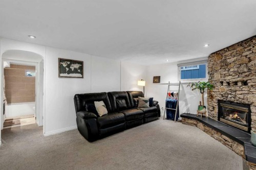 9939 Maplecreek Drive Se, Calgary, AB - Indoor Photo Showing Living Room With Fireplace