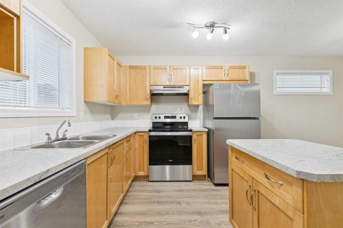 475 Cimarron Boulevard, Okotoks, AB - Indoor Photo Showing Kitchen With Double Sink