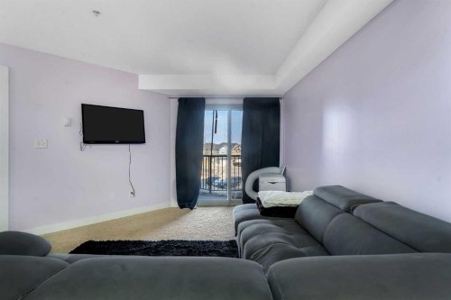 318-7210 80 Avenue Ne, Calgary, AB - Indoor Photo Showing Living Room